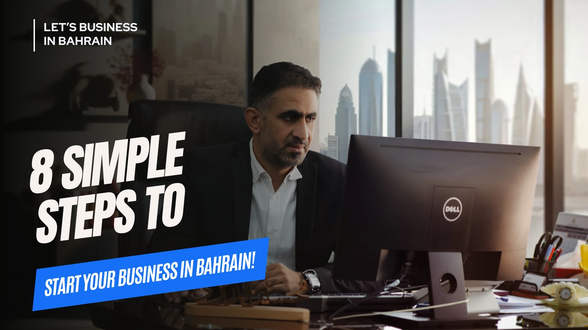 Start Your Business in bahrain a man sitting in front of a computer