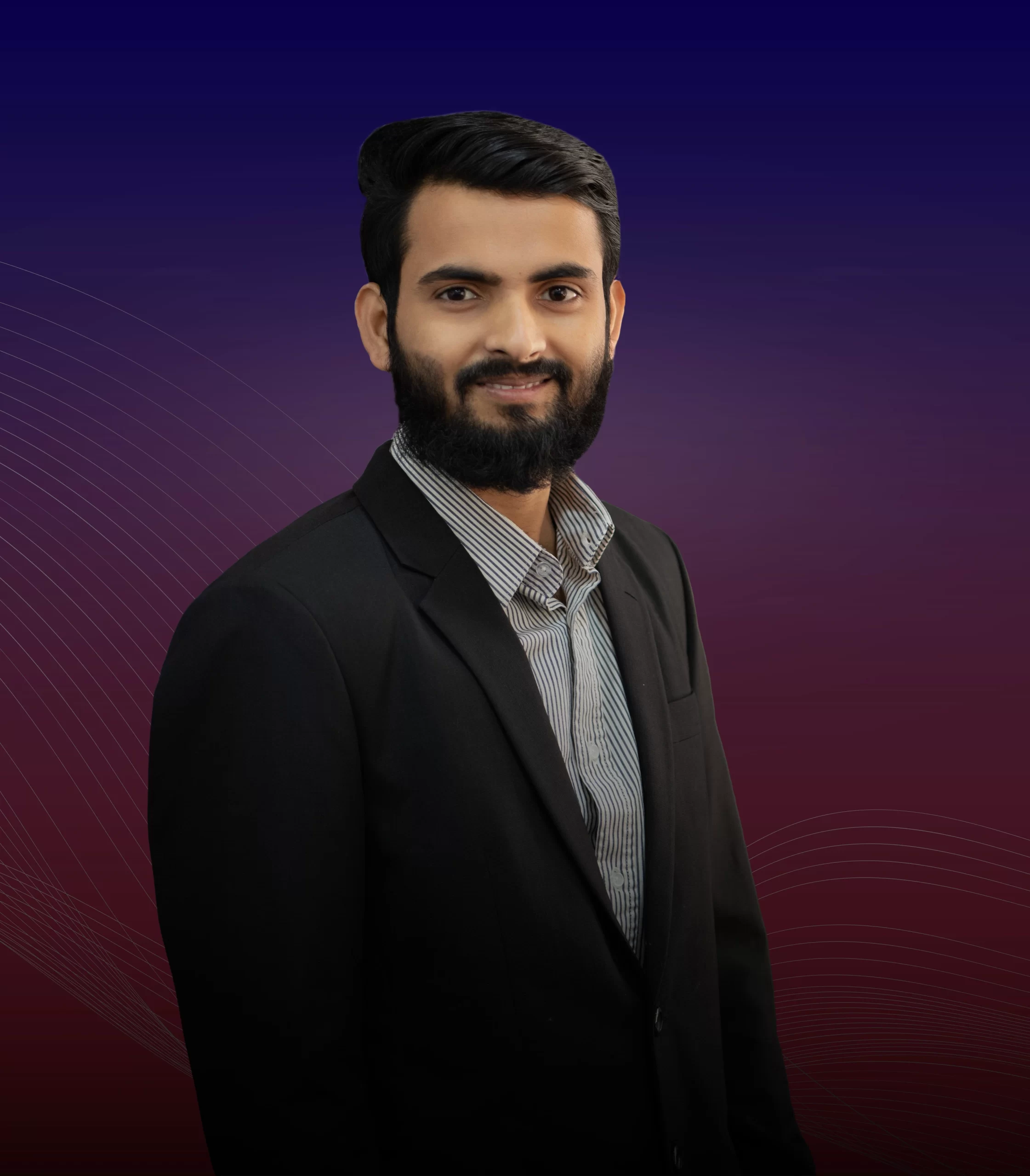 A man in a suit and tie smiling, embodying professionalism and confidence as he poses for a portrait named Rayhan Chowdury.